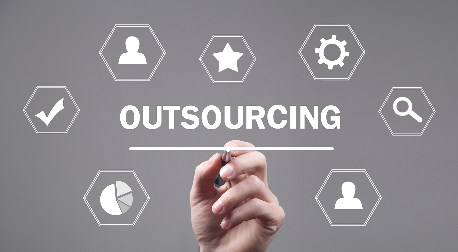 Male hand writing in screen. Outsourcing. The image is trying to depict payroll outsourcing services.
