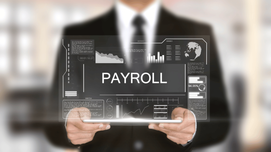 The images mentions Payroll outsourcing for businesses. There ia man in black suit holding a pc with screen depicting payroll.